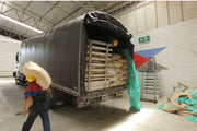 Photo of a truck being unloaded at Caravela’s dry mill in Armenia, Colombia.
